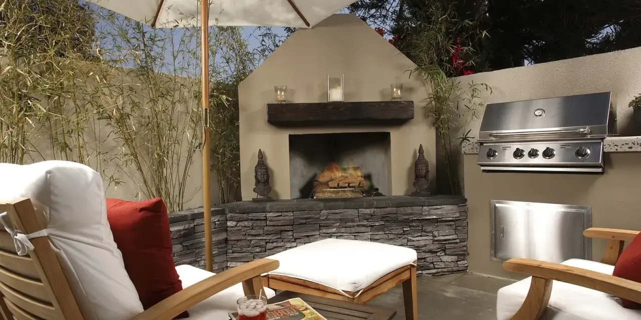 Un patio privado con chimenea, parrilla y cómodos asientos bajo sombrilla. Ideal para techar patio comunitario de uso privativo.