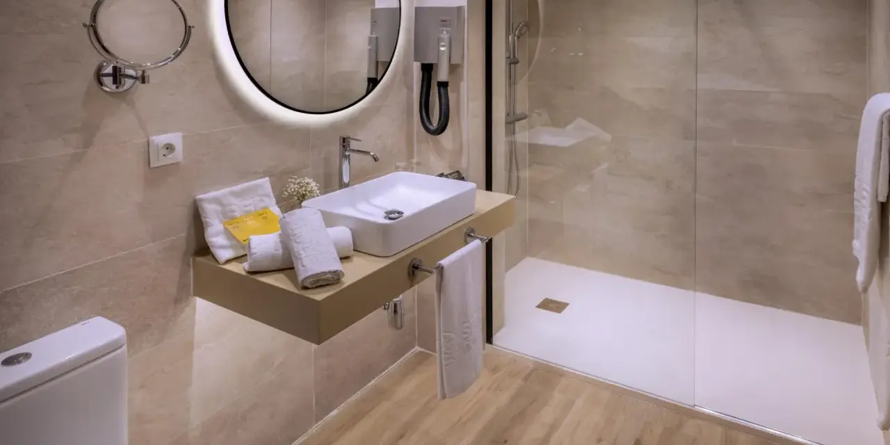 Baño moderno con ducha, lavabo y WC. Se podría pensar que para cambiar bañera por ducha hace falta licencia de obra, pero aquí ya está hecho.