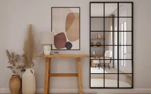 Una elegante entrada para una casa con consola de madera, lámpara, arte abstracto y espejo industrial.