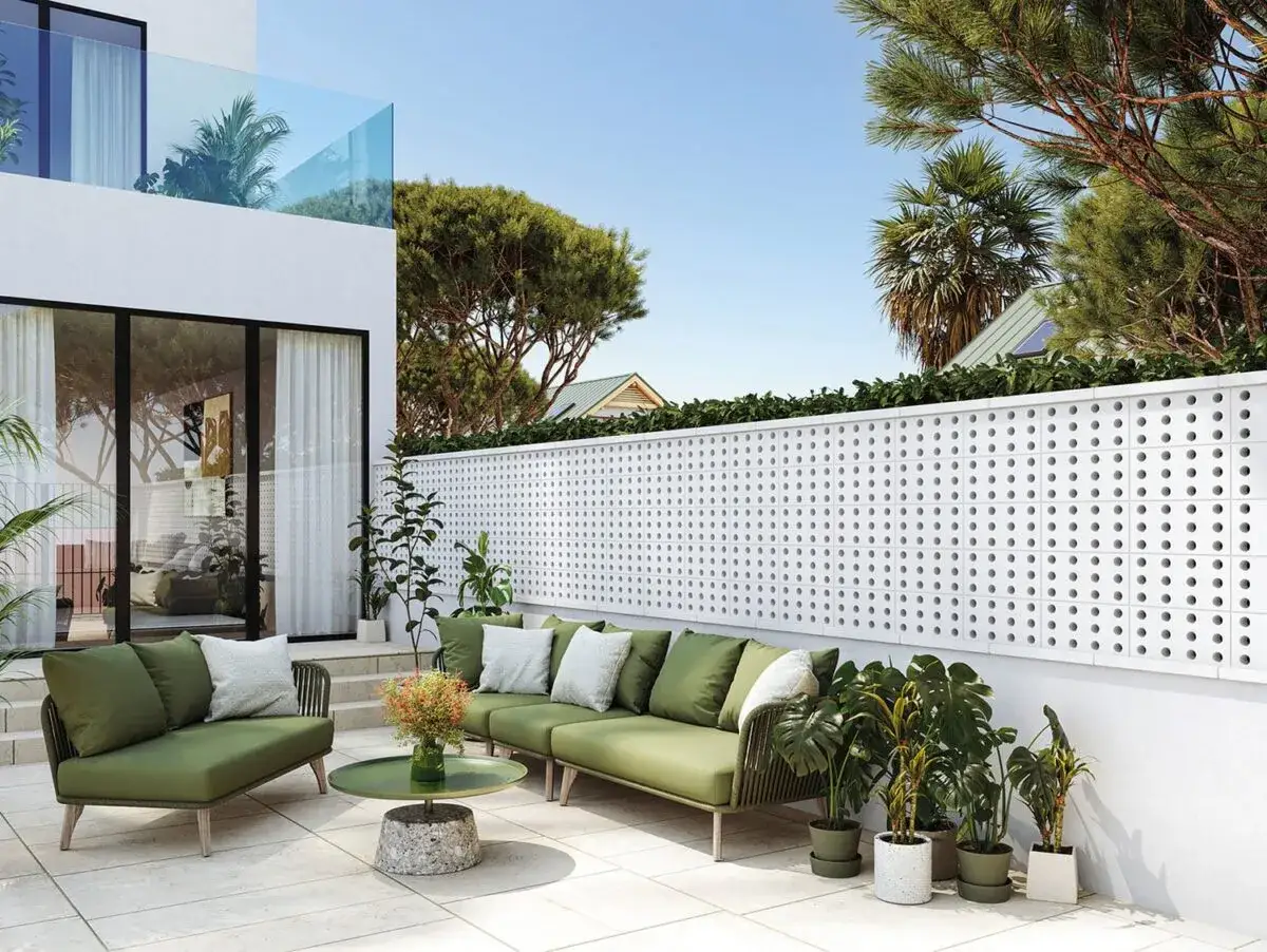 Modern exterior with green sofas and plants, creating charming enclosed terraces.