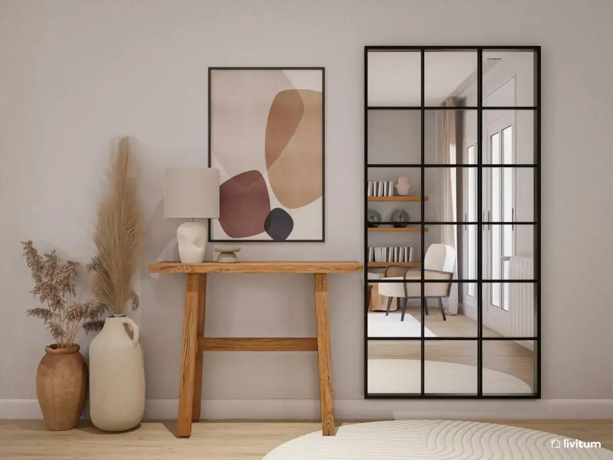 Una elegante entrada para una casa con consola de madera, l&aacute;mpara, arte abstracto y un espejo grande con estilo industrial.